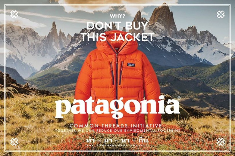 A picture of an orange parka on a background with high mountains